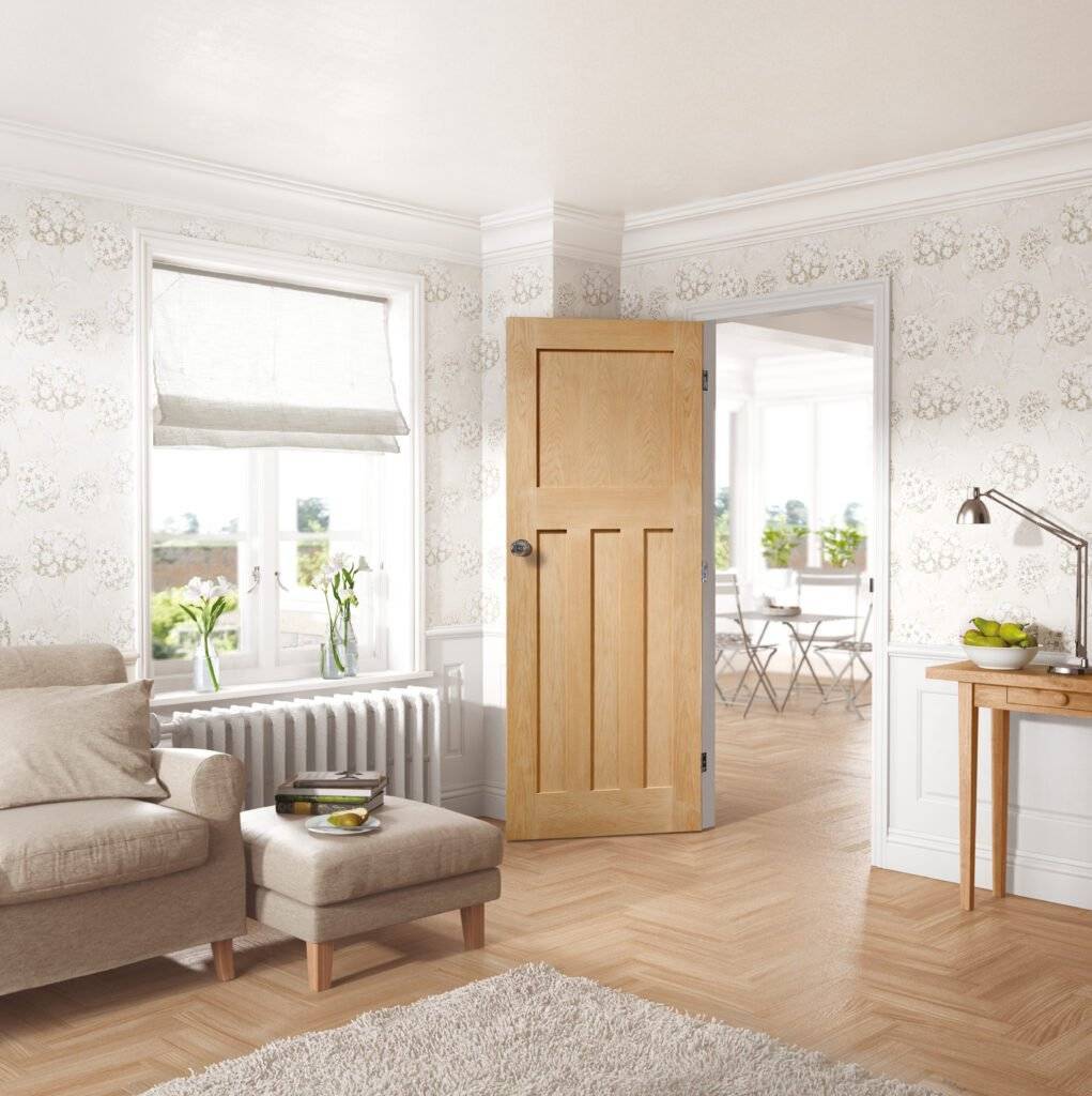 Living room with wooden door, sofa, and decorative elements.