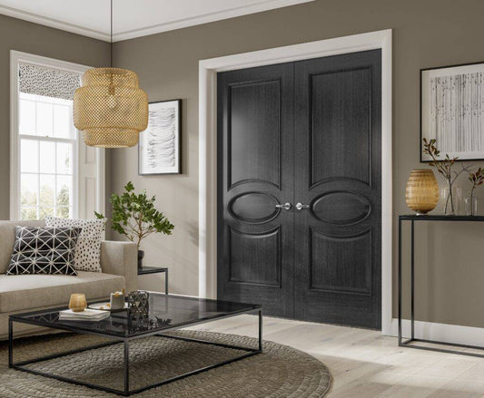 Modern living room with a black double door, gray walls, and decorative elements.