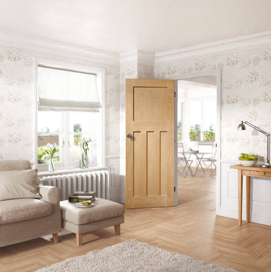 Living room with wooden door, sofa, and decorative elements.