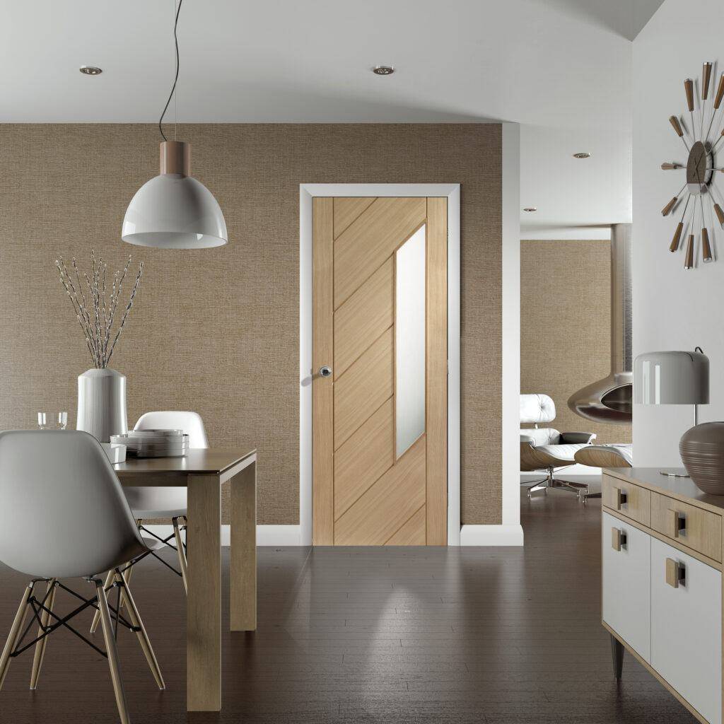 Modern interior with wooden door, dining table, and kitchen area.