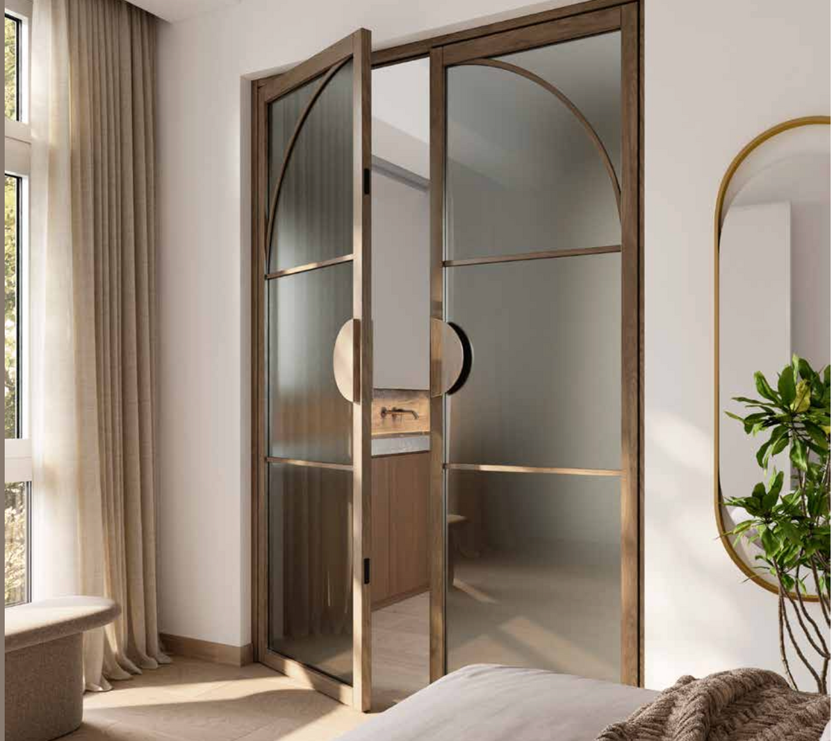 Arched double glass doors with a bronze metal frame and circular cutout handles, shown in an open position within a modern bedroom interior.
