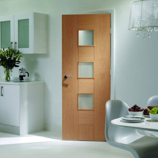 Wooden interior door with glass panels in a modern kitchen setting