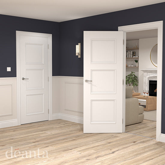 White interior doors in a room with dark blue walls and wooden flooring.