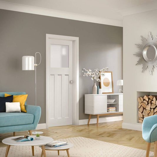Modern living room with gray walls, a white door, and decorative elements.
